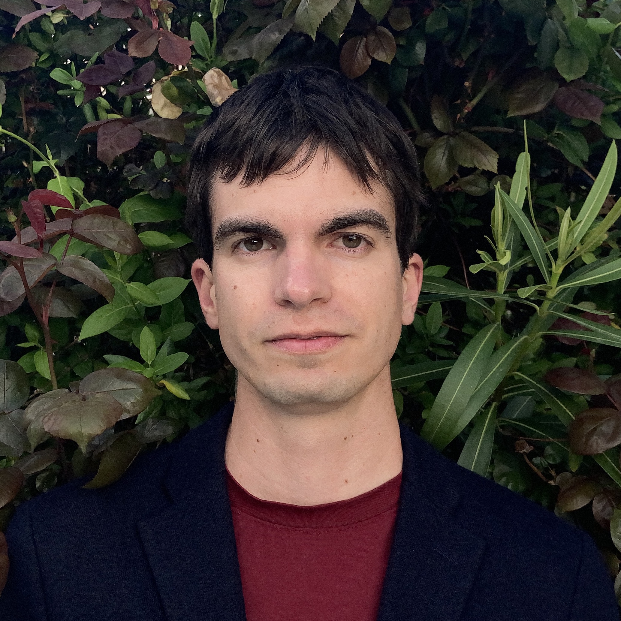 Profile of Jay Langford in front of a bush.